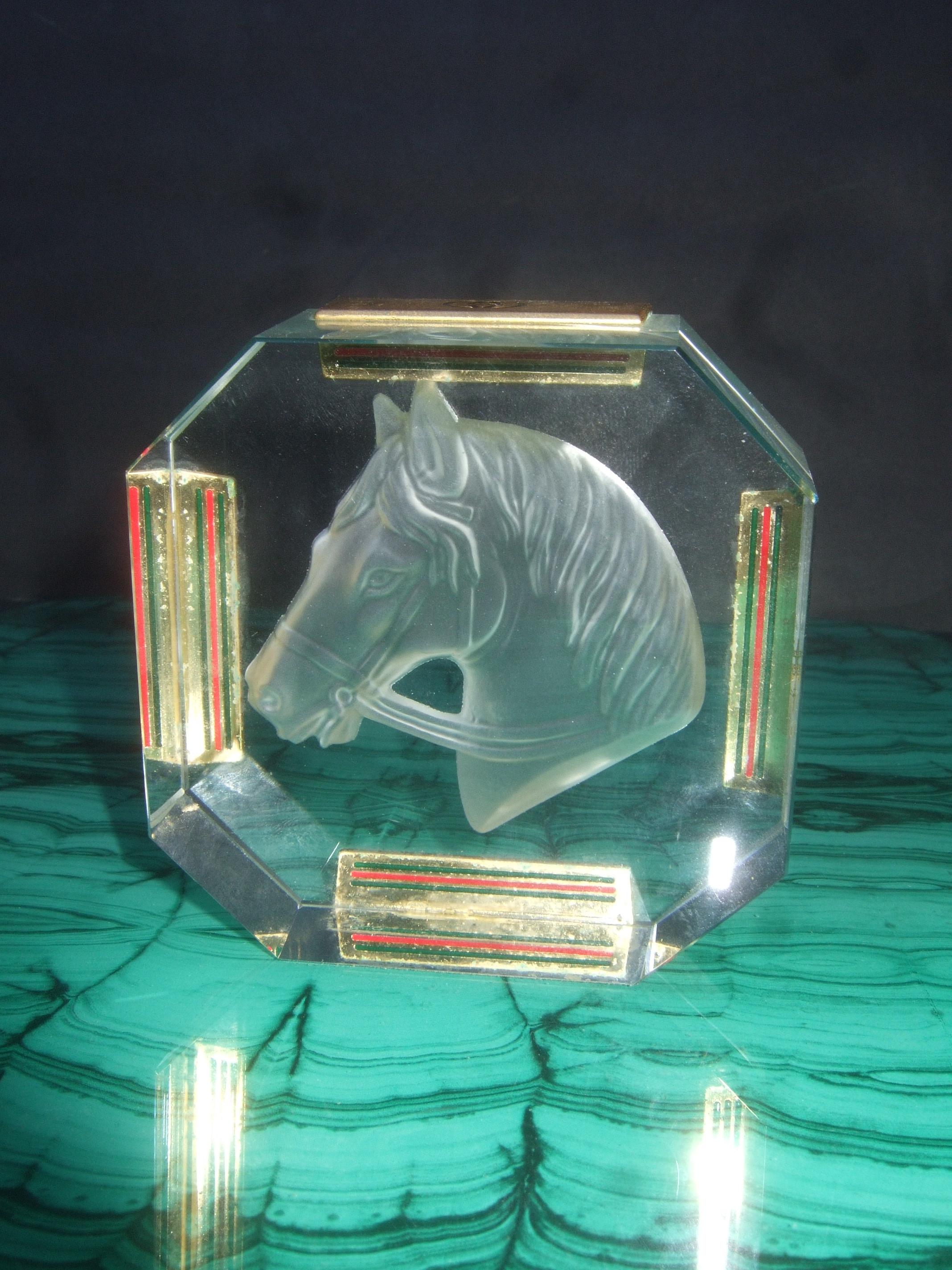 Gucci Crystal intaglio equine octagon paper-weight c 1970s 
The elegant crystal paper-weight is designed with a majestic intaglio horse head figure

Four of the sides are adorned with gilt metal rectangular plates inscribed with Gucci's interlocked