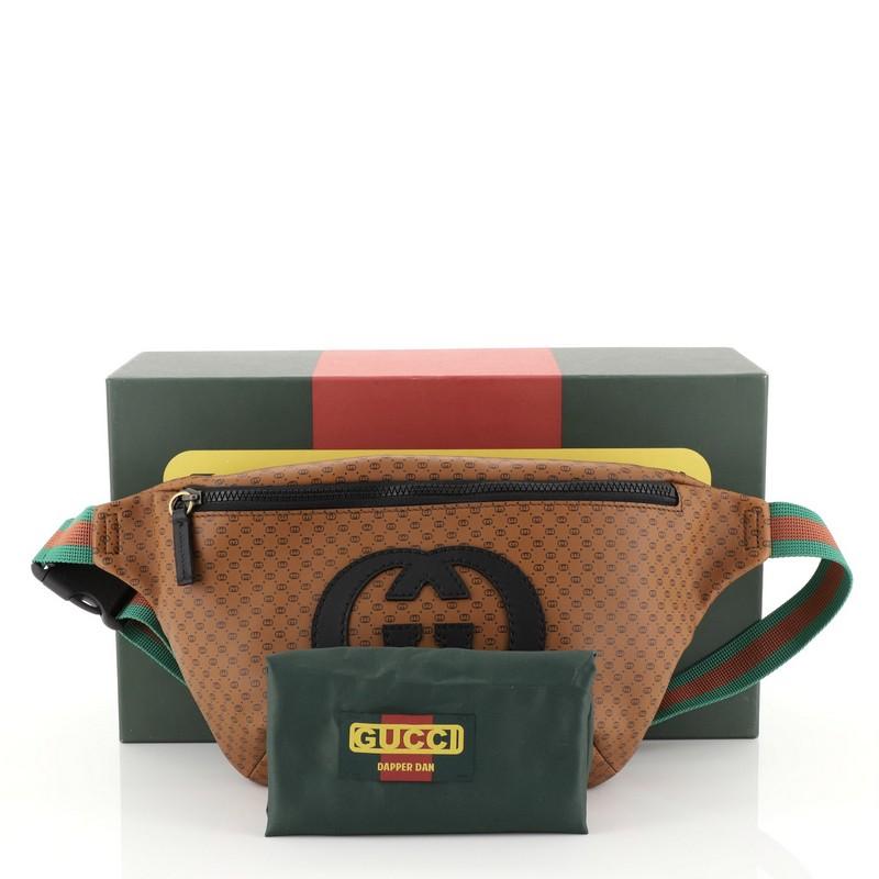 This Gucci Dapper Dan Belt Bag GG Print Leather, crafted from brown GG print leather, features adjustable web belt strap and aged gold and black-tone hardware. Its zip closure opens to a black nylon interior. 

Estimated Retail Price: