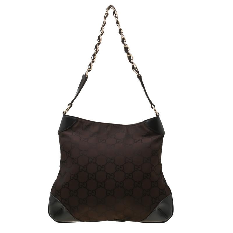 Easy and comfortable for everyday use with a touch of luxurious style that will never go out of style, this Gucci hobo will last you through seasons. Crafted in dark brown GG canvas and accented with leather details, this bag opens with a top zipper