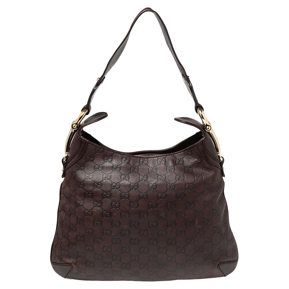 This Gucci hobo might just be your next favorite handbag. It is high in style and is functional enough to accompany you on all your busy days. The bag comes crafted with GG leather and hosts a spacious canvas interior. The hobo is held by a single