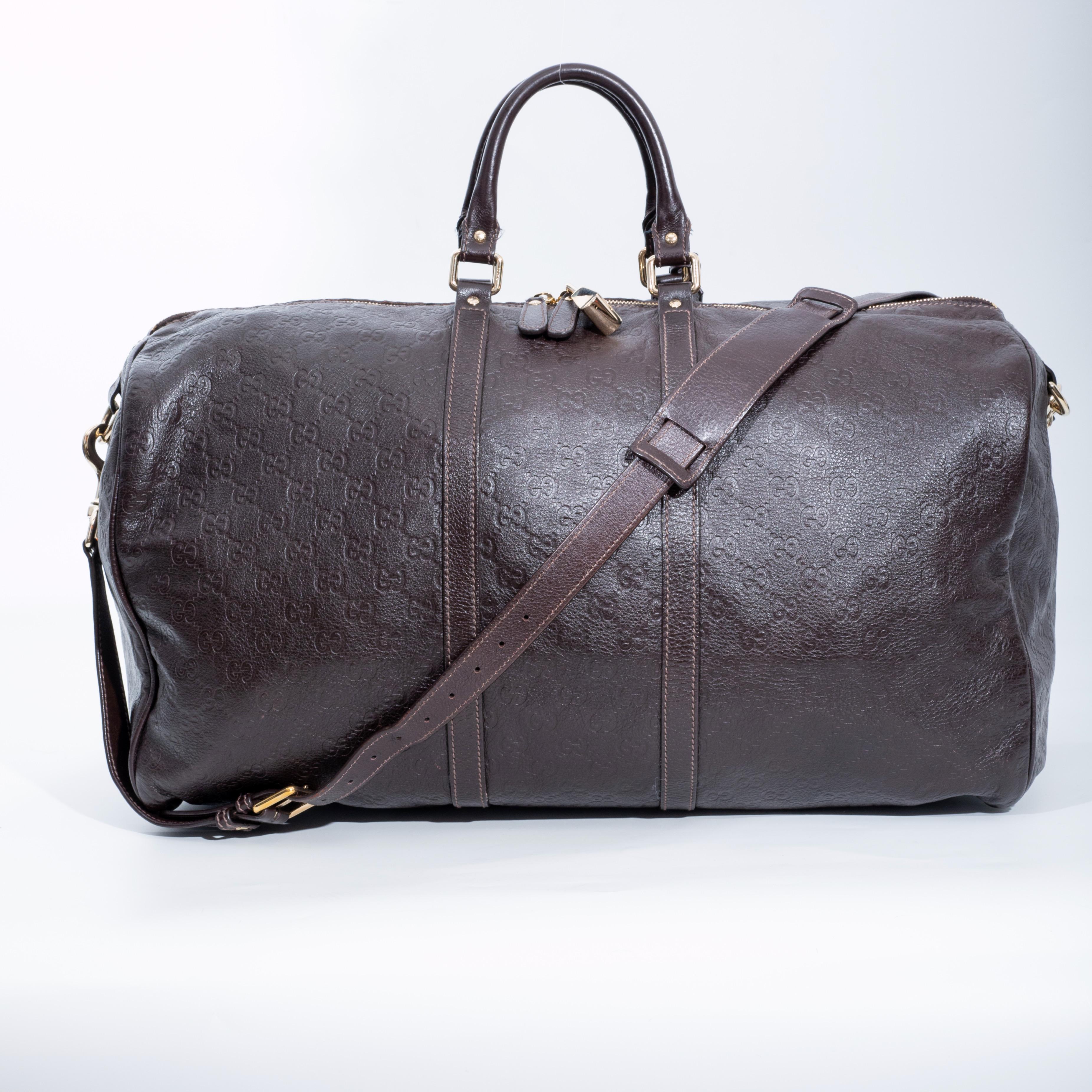 This travel duffel is made of Gucci monogram embossed Guccissima leather. The bag features rolled leather top handles, an optional shoulder strap, light gold hardware, dual top zip closure and logo monogrammed fabric lining. This is an excellent