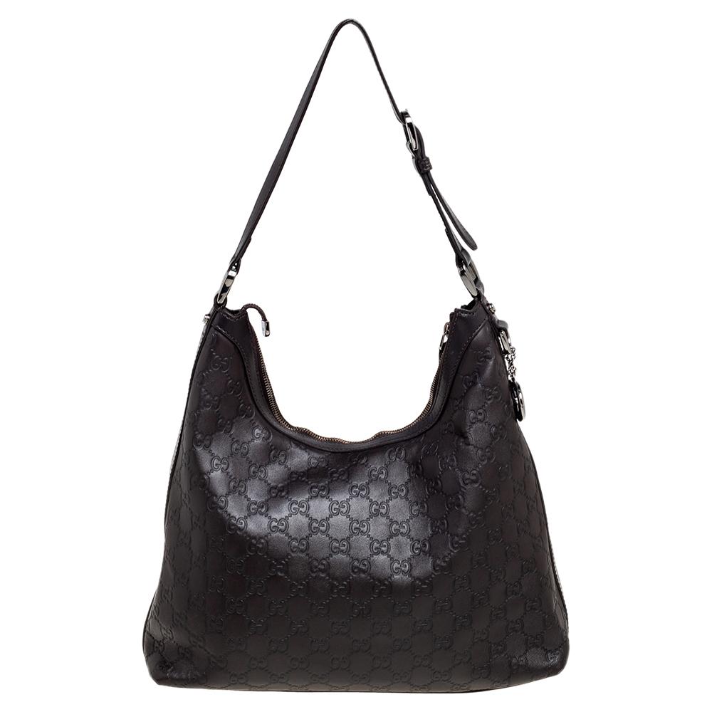 This beautifully stitched Guccissima leather hobo is by Gucci. With a capacious fabric-lined interior, a comfortable handle, and a fine finish, this dark brown hobo is bound to offer style and practical ease.

Includes: Original Dustbag
