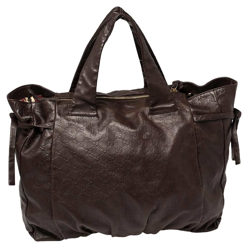 This Gucci Hysteria bag is built for everyday use. Crafted in Italy, it is made from Guccissima leather and comes in a dark brown hue. It has ties on the sides and dual handles for you to parade it. The fabric interior is spacious and is secured