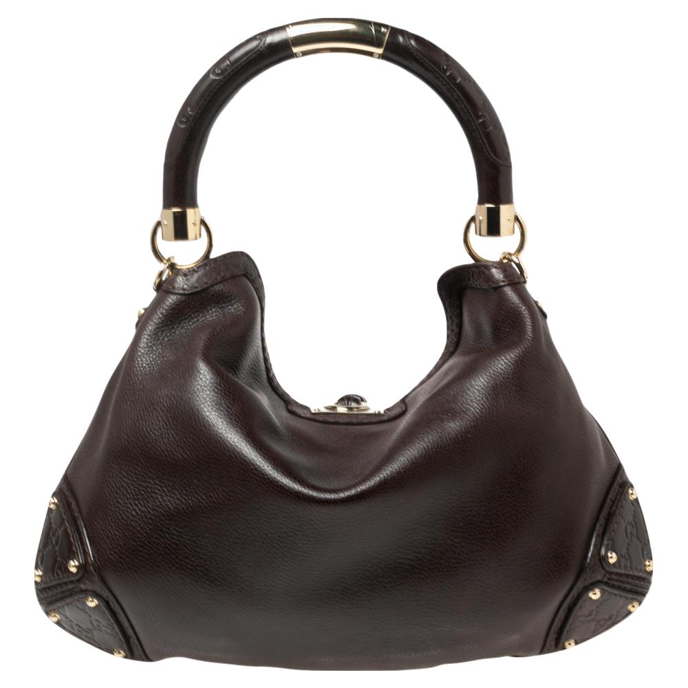 We can always count on Gucci for styles that we love now and later. This gorgeous Gucci Babouska Indy hobo is crafted in Guccissima leather. It features a chic design with a top handle, double tassels with bamboo details, and gold-tone hardware.