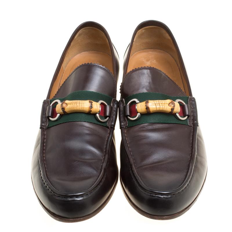 These dark brown loafers by Gucci are structured in the label's signature style to make a refined and suave move. Crafted from leather, they feature the signature red and green striped web along with bamboo and horsebit detailing. The insoles are