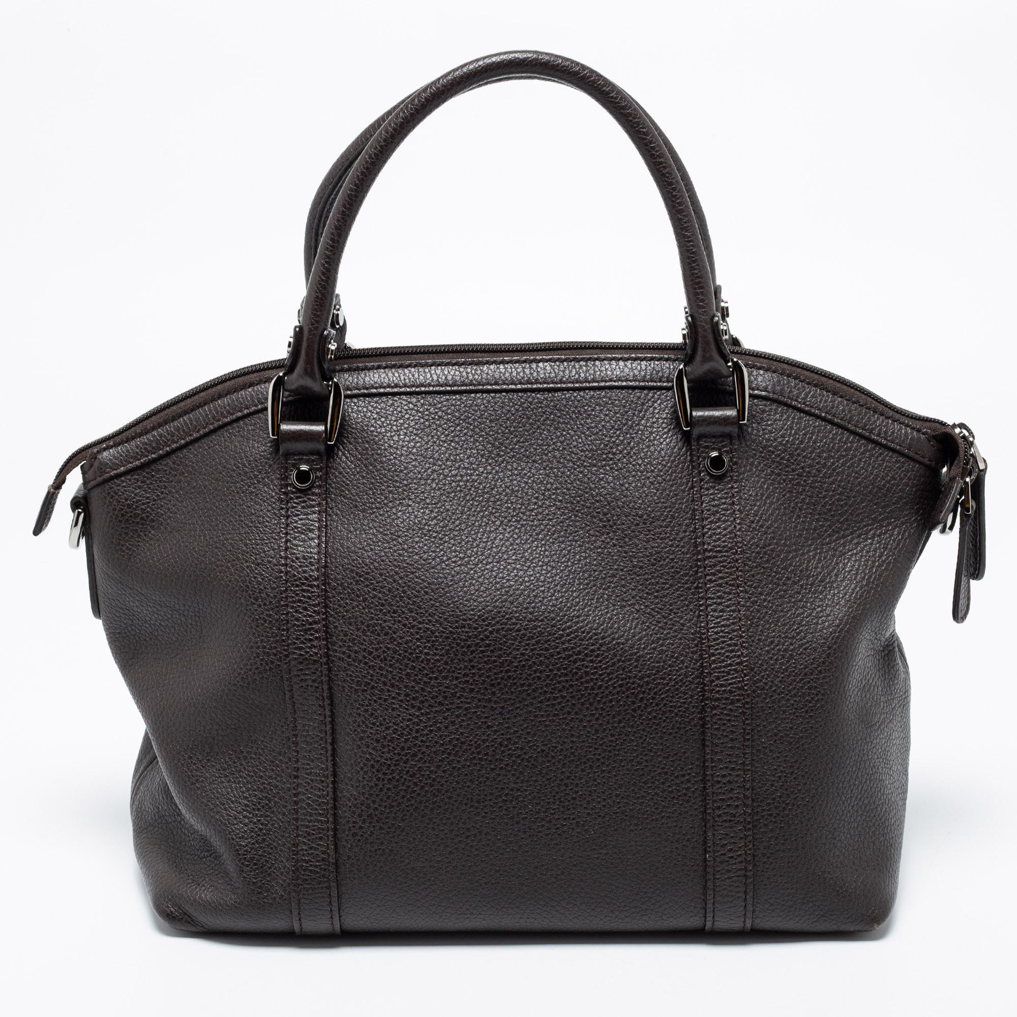 Compact and handy, this Dome satchel from the House of Gucci will work well as an everyday accessory. It is crafted from dark-brown leather, which features GG charms on the front. It is adorned with Dark Ruthenium hardware, a leather-fabric