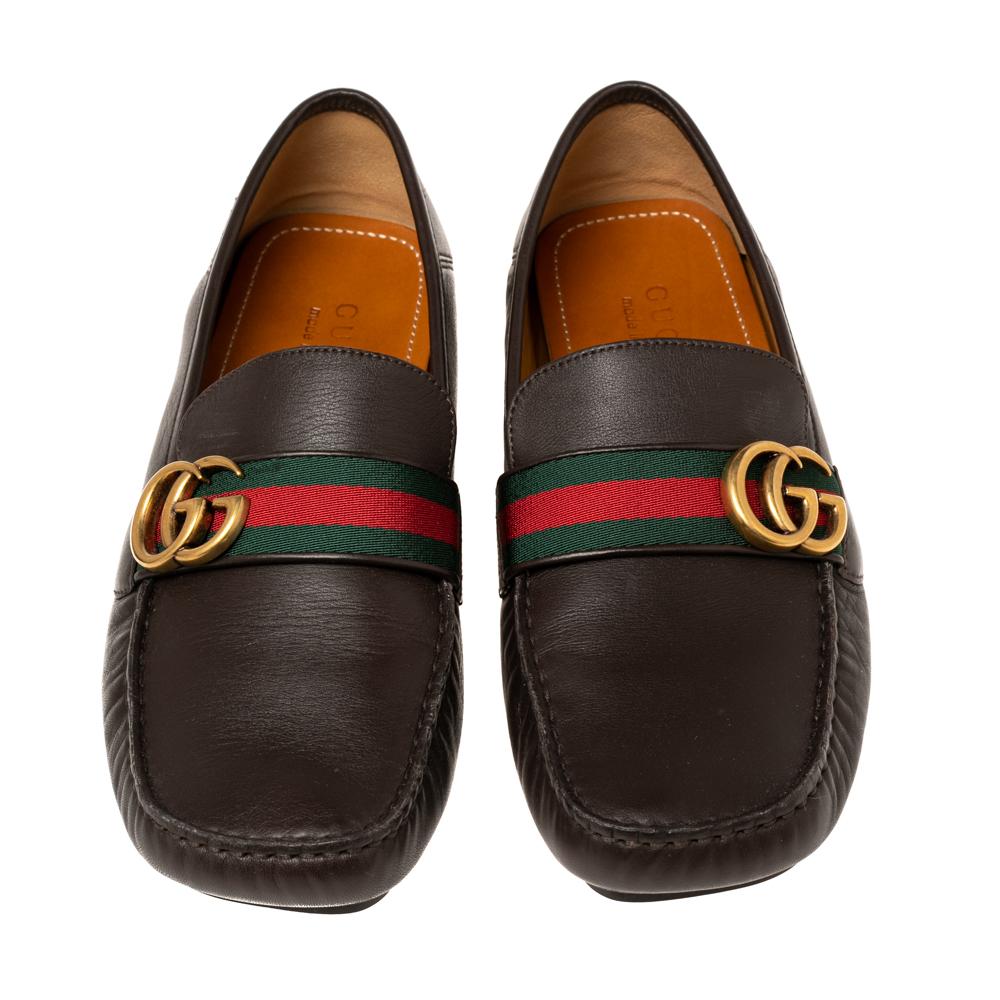The house of Gucci brings to you these super-stylish loafers that have been made from leather. They flaunt the signature Web stripes along with the brand logo on the front. Team the dark brown shoes with a smart suit for a suave look.

Includes:
