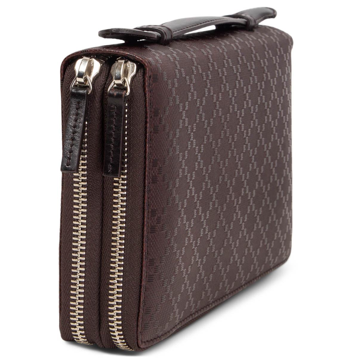 100% authentic Gucci top handle travel wallet in dark brown calf skin. Opens with two zippers and is lined in dark brown calf leather. Comes with a zipper coin pocket, 22 credit card slots, two extra slit pockets, a pen holder,  and four big slit