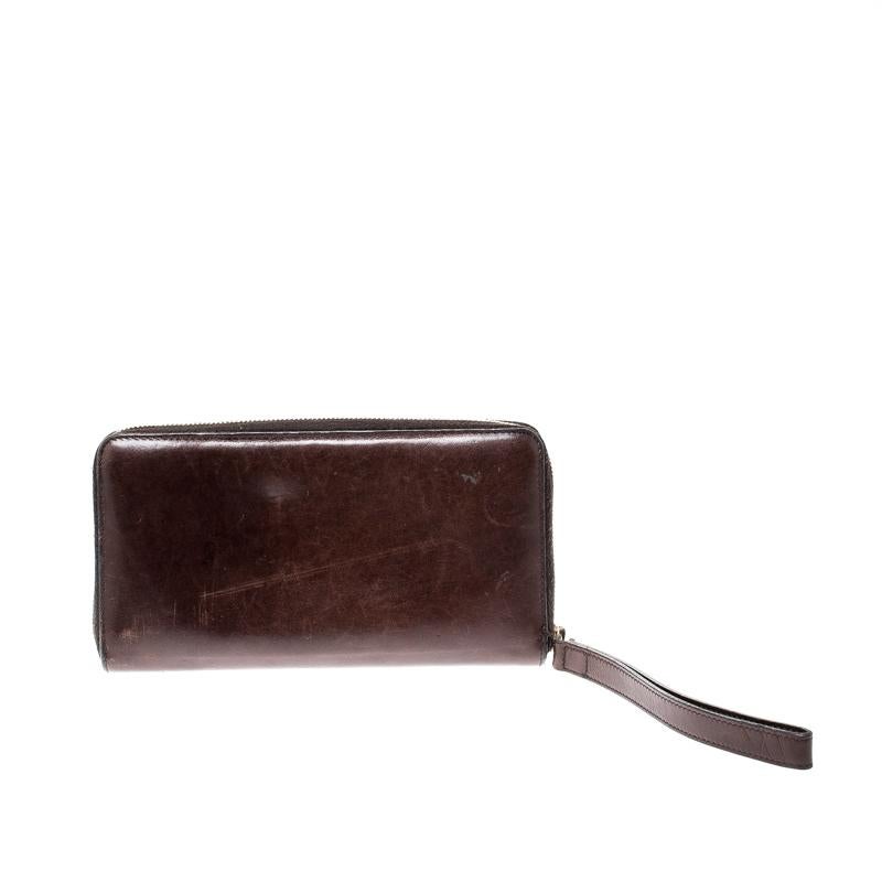 This dark brown wallet from Gucci is worth the buy! It is crafted from leather and features a zip closure that opens to reveal cards slots and a zip pocket. Carry your cash and cards securely in this creation that will fetch you compliments from one