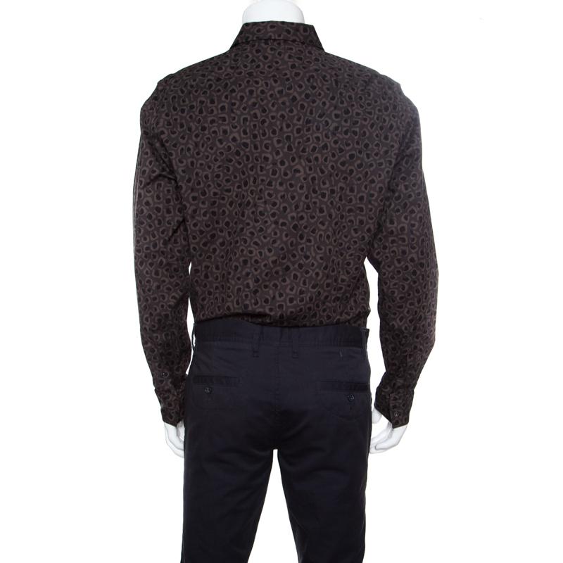 Shirts are an essential wardrobe staple for every man and this Gucci shirt is one such fabulous creation that is worthy of being a part of your closet. This dark brown shirt is made of a cotton blend and features a leopard printed pattern all over