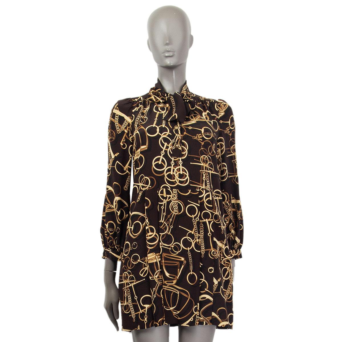 100% authentic Gucci pussy-bow pleated longsleeve dress in brown and beige horsebit and stirrup printed dress in silk (100%). Has four embossed antique gold-tone metal buttons at front and two side slit pockets. Has been worn and is in excellent