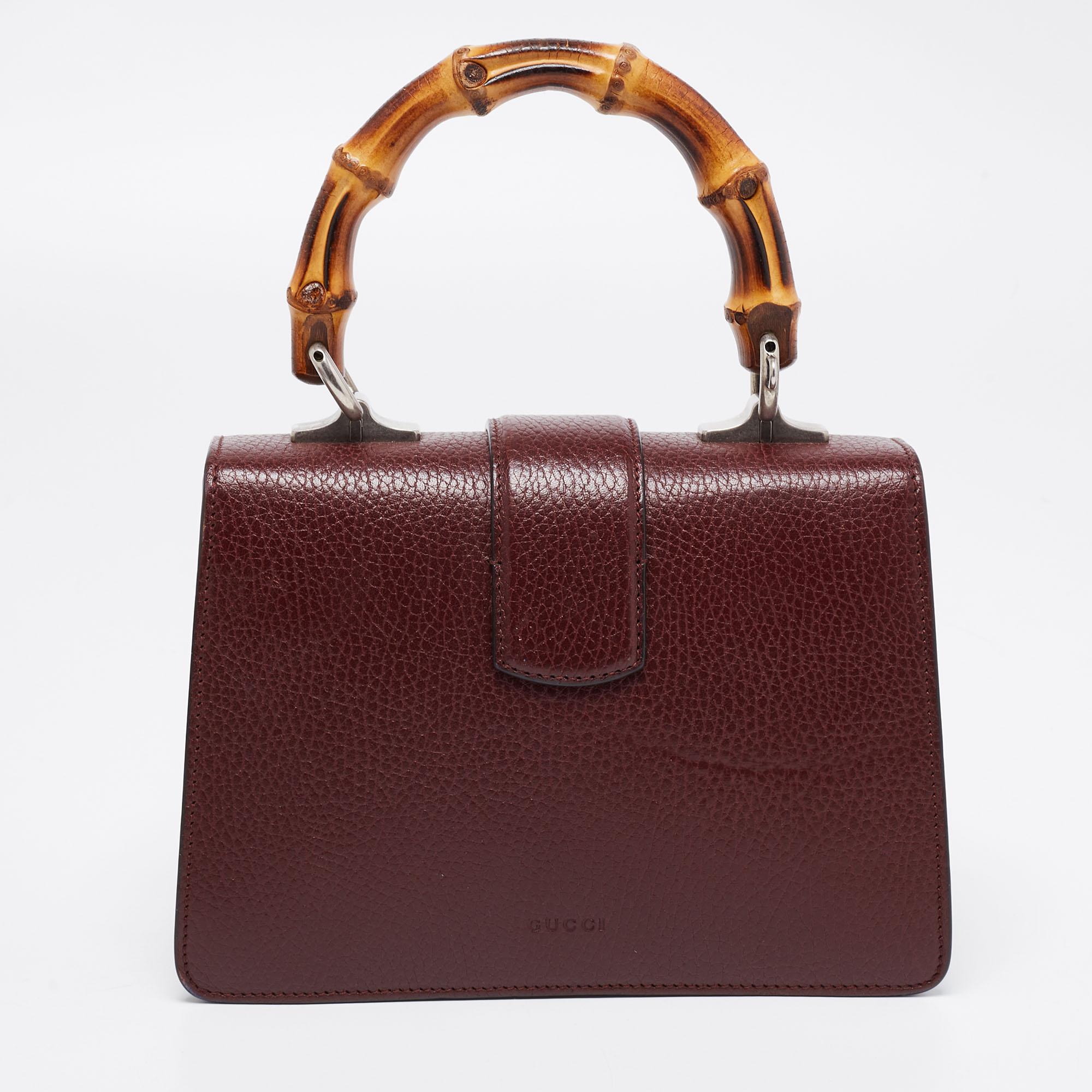 Gucci's Dionysus collection is inspired by the Greek God who is believed to have crossed the Tigris river on a tiger given to him by his father, Zeus. This creation has been beautifully made from leather in a dark red hue. The flap secures the