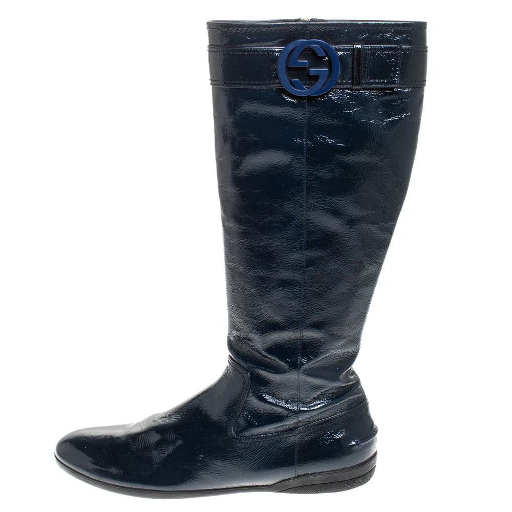 Perfect for the winter season, these Gucci knee boots are going to be your best buy. Crafted in dark teal patent leather, these Italian-made boots feature comfortable round toes and sturdy outsoles. They are finely lined in leather for durability.