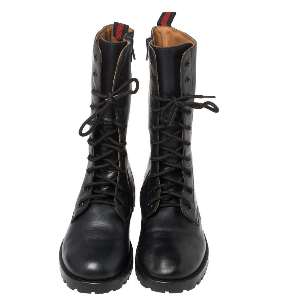 Gucci's combat boots prove that comfort and style do, in fact, go hand in hand. Set on gripped rubber soles that'll weather most terrains, they're punctuated with lace-ups, GG logo on the sides, and Web stripe pull tabs. They are made of