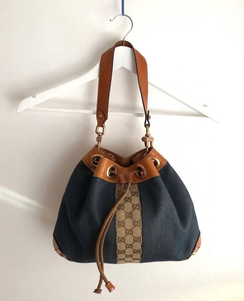 FREE UK and WORLDWIDE DELIVERY 

Stunning and rare vintage GUCCI denim and leather bucket bag, GG monogram stripe detail, condition is like new, no rips, smells or faults, siege drawstring, heavy metal work.

Condition: vintage, 1990s, excellent,