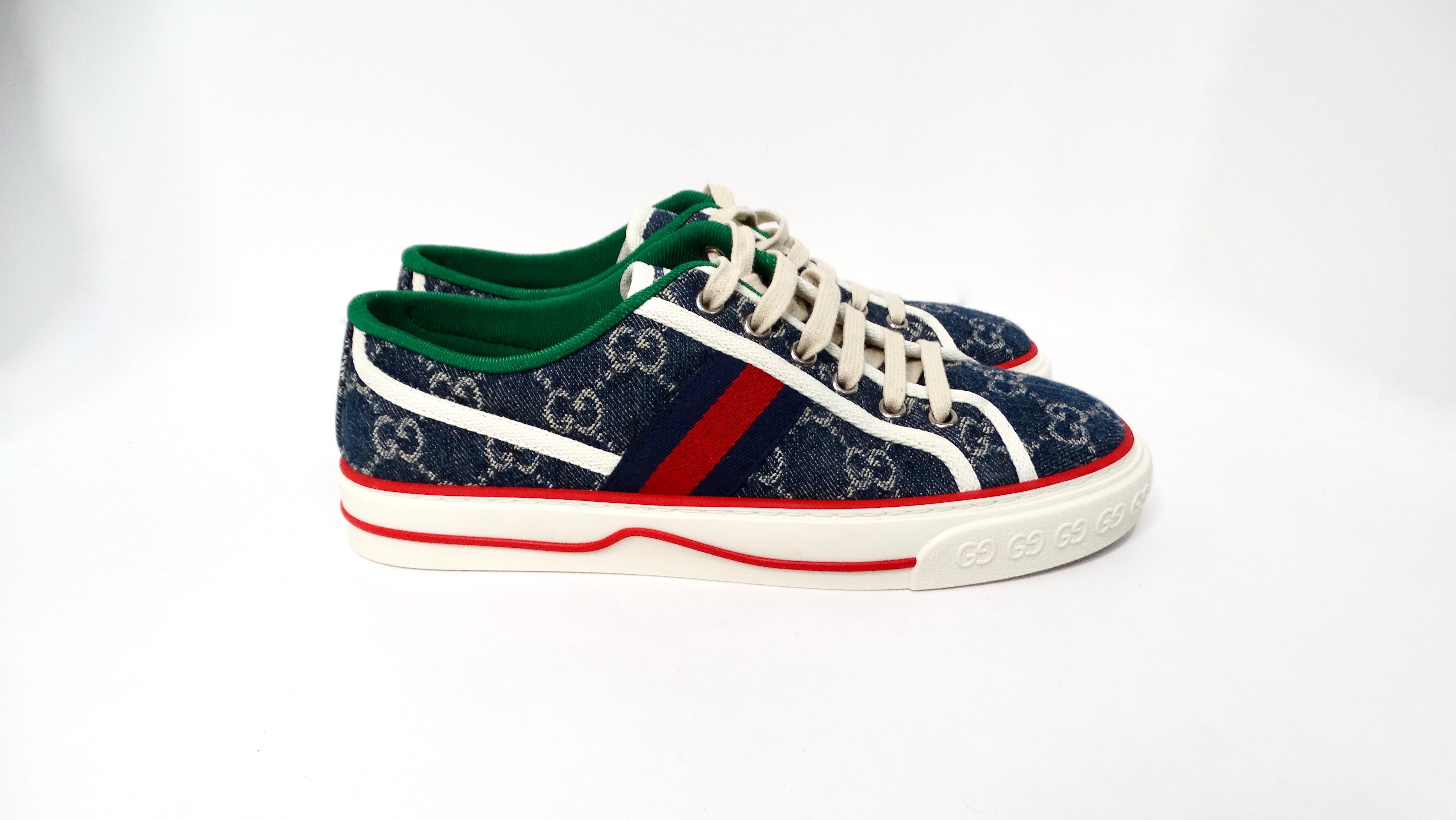 The Gucci Denim Monogram Web 1977 Tennis Blue Sneakers embody a delightful fusion of casual style and luxury allure. Crafted from denim adorned with the iconic Gucci monogram, these sneakers present a fresh take on classic athletic footwear. The