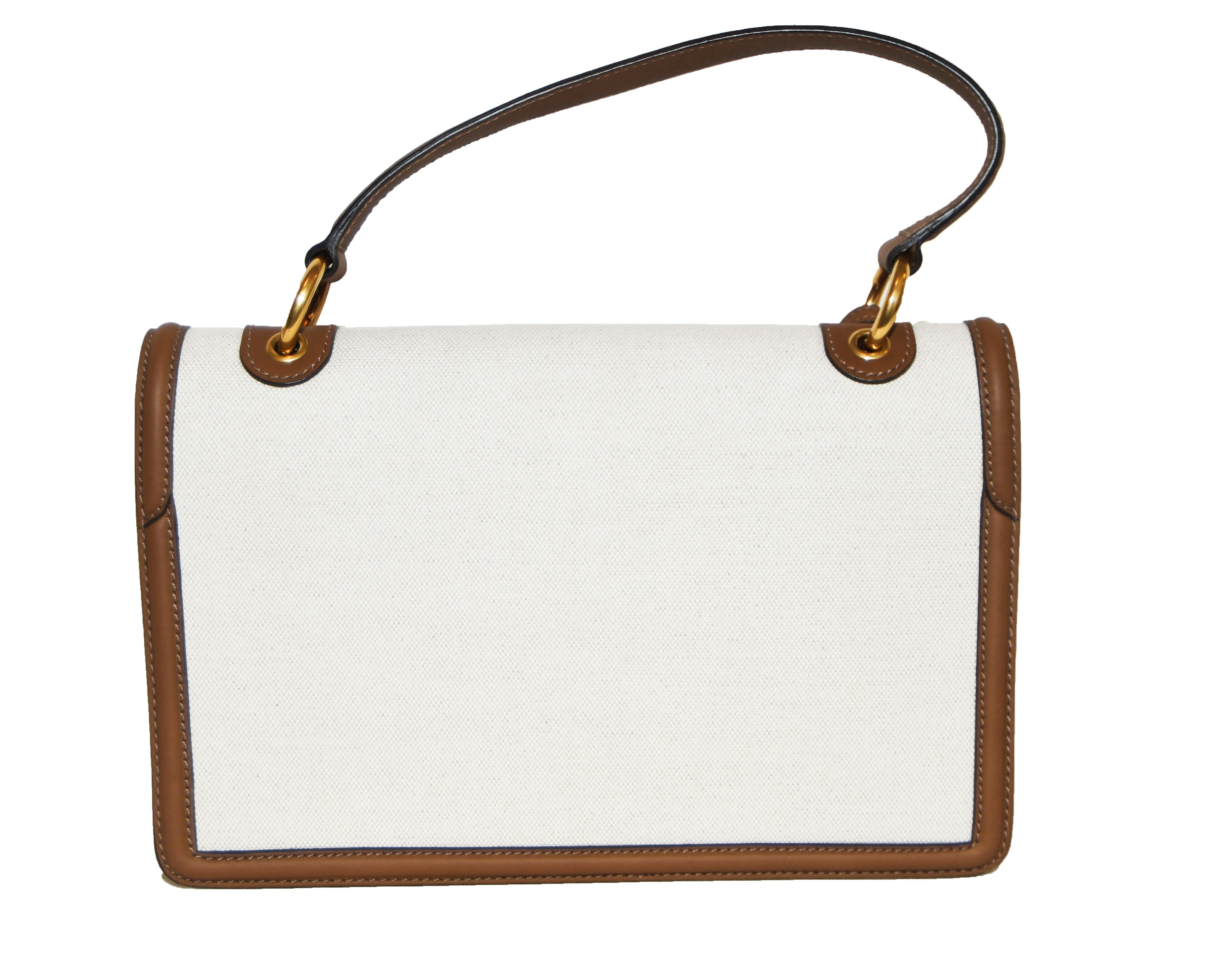white luggage with brown leather trim