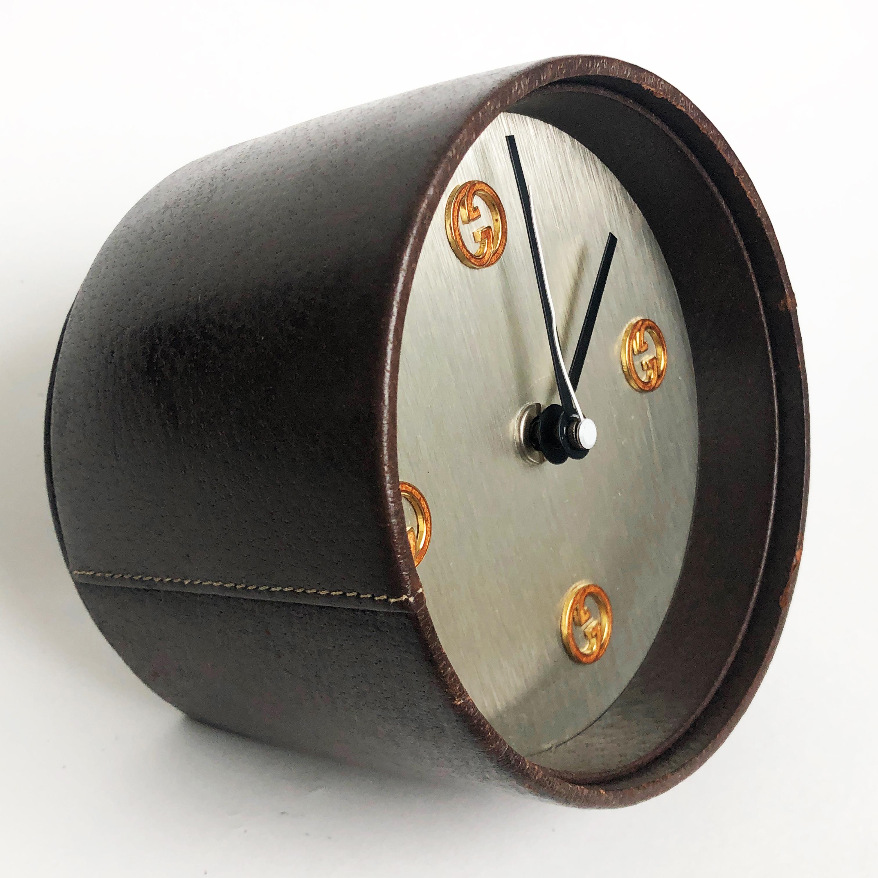 Authentic, preowned, vintage Gucci desk clock, circa the early 1980s. Covered in pigskin leather, with GG logo motif hour markings. This piece originally came with a battery operated movement by well-known German clock maker, KIENZLE, however it was