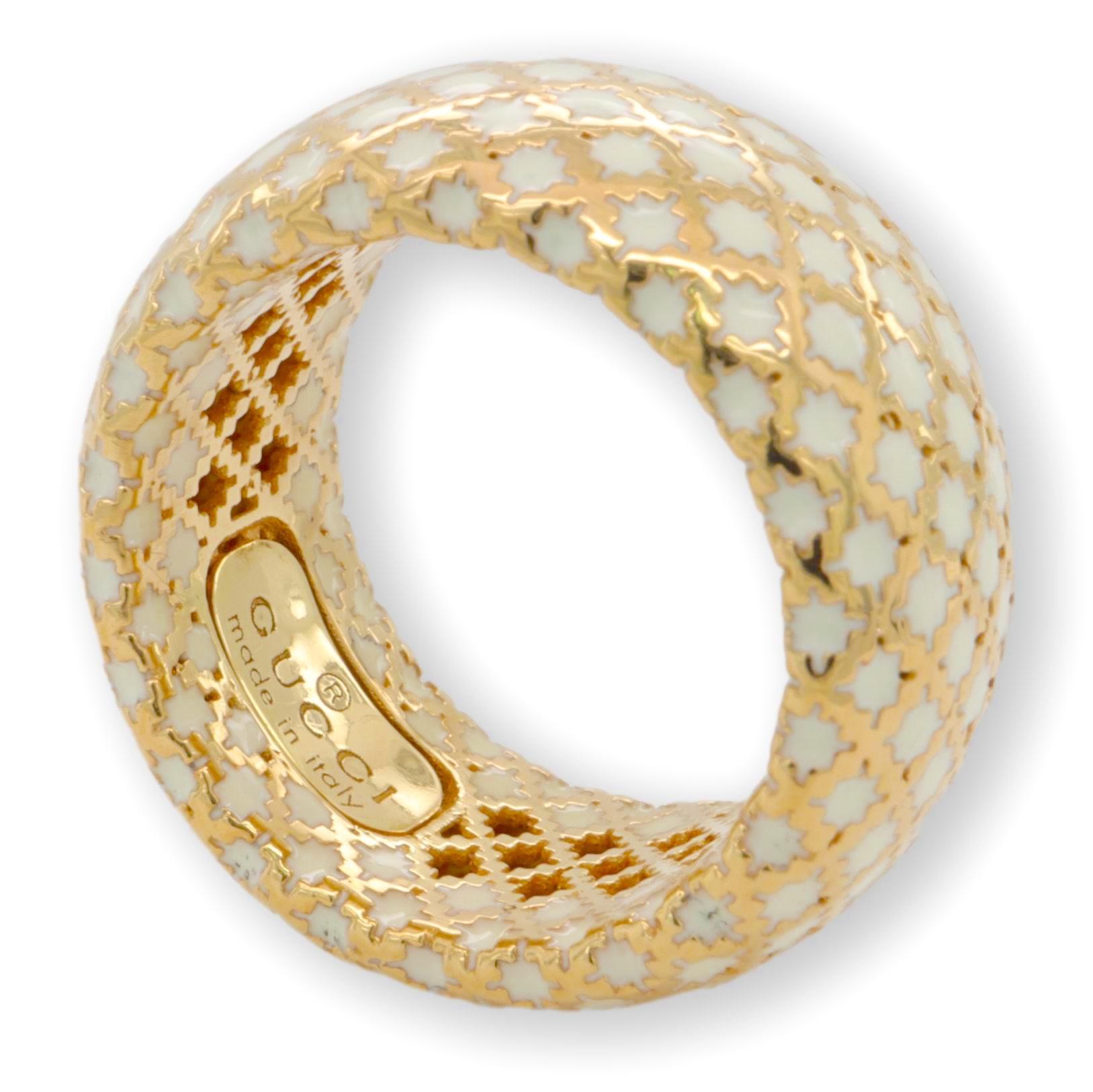 A beautiful 18 Karat yellow gold and white enamel band dome style ring by Gucci, from their well known 