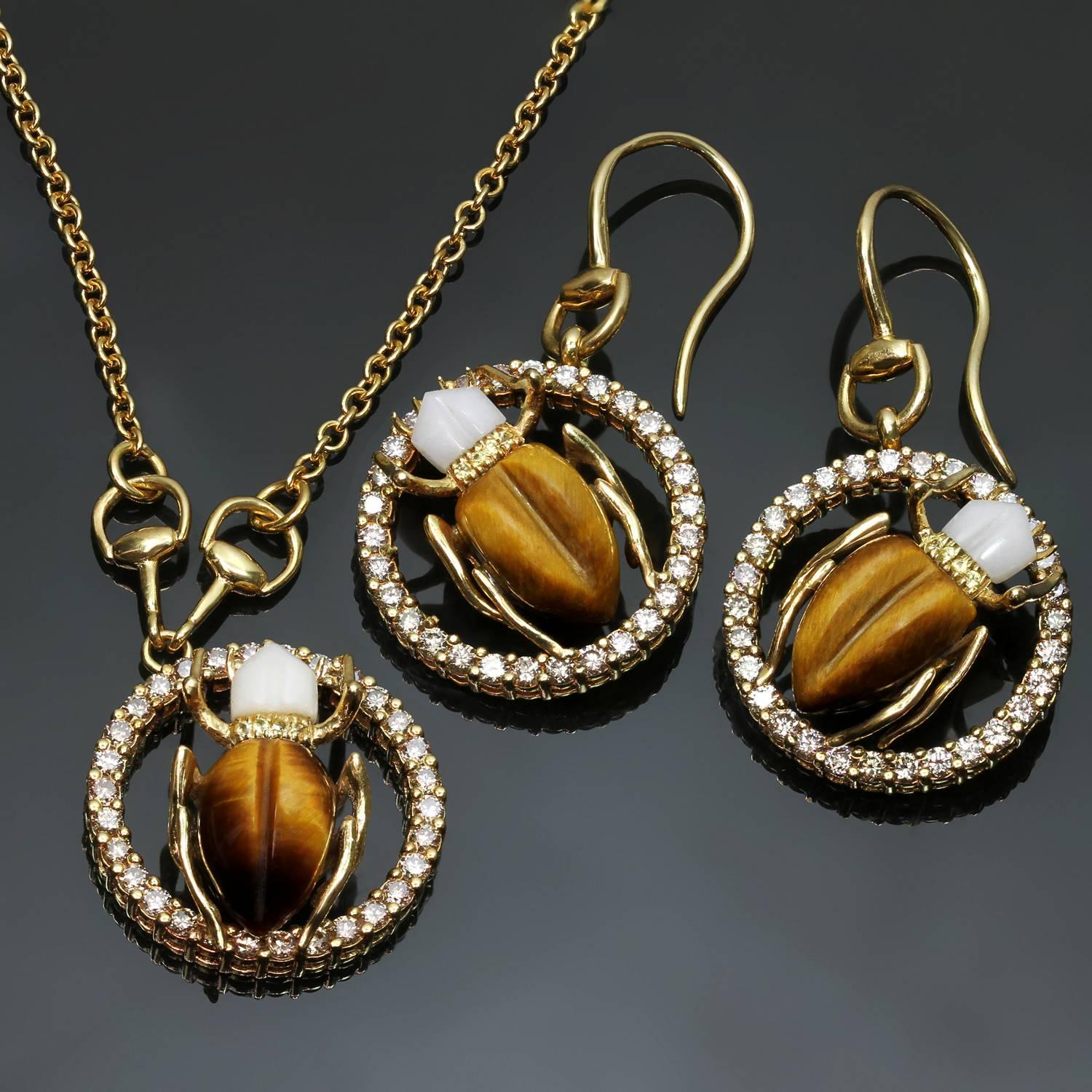 These lively and sparkling Gucci drop earrings & pendant necklace set feature a scarab beetle design crafted in 18k yellow gold and accented with champagne diamonds of an estimated 2.70 carats, yellow sapphire, white agate, and tiger's eye. Made in