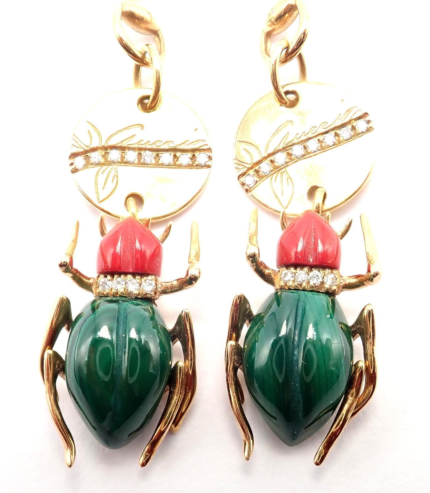 18k yellow gold Diamond Malachite Carnelian Scarab Drop Earrings from Gucci.
These Gucci earrings feature intricately crafted scarab beetles in rich malachite and vibrant carnelian, set in luxurious 18k yellow gold. 
Sparkling diamonds accent the