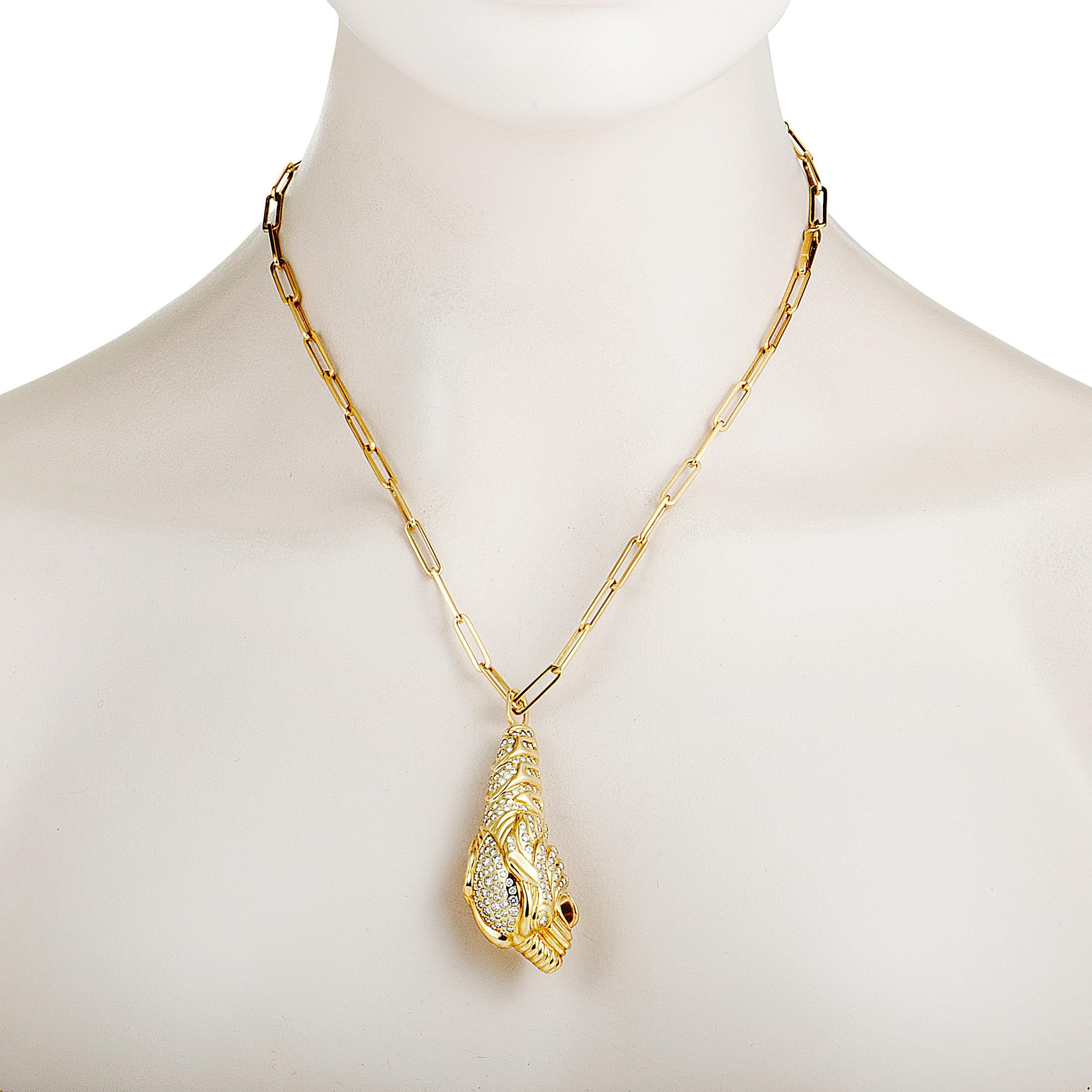 This stunning necklace designed by Gucci boasts a compelling panther pendant that is lavishly decorated with dazzling diamonds and presented on a stylish chain. The necklace is wonderfully made of radiant 18K yellow gold and it is set with a total