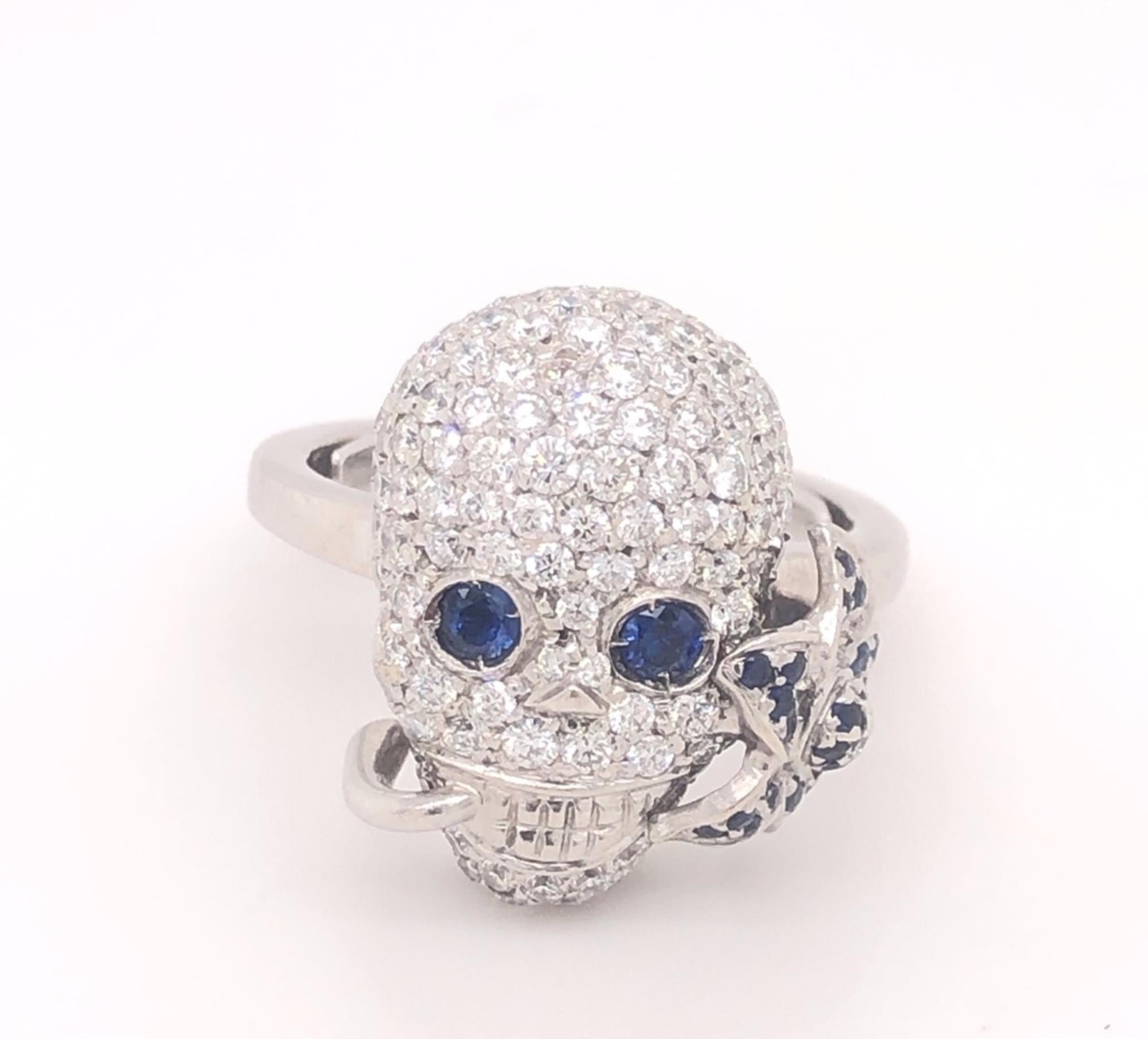 Authentic Gucci Diamonds Sapphires Flora Skull Ring 18K White Gold. This is a stunning skull ring set with pave diamonds and natural sapphire eyes and flower in his mouth. The retail price from Gucci is $9850. The diamonds are H color VS-2 clarity