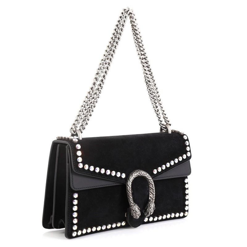 This Gucci Dionysus Bag Crystal Embellished Suede Small, crafted from black suede, features a chain link strap, rhinestone embellishments, textured tiger head spur detail on its flap, and aged silver-tone hardware. Its hidden push-pin closure opens