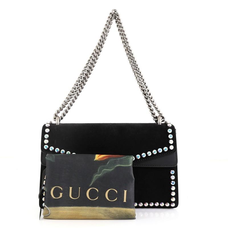 This Gucci Dionysus Bag Crystal Embellished Suede Small, crafted from black suede, features a chain link strap, crystal embellishments, textured tiger head spur detail on its flap, and aged silver-tone hardware. Its hidden push-pin closure opens to