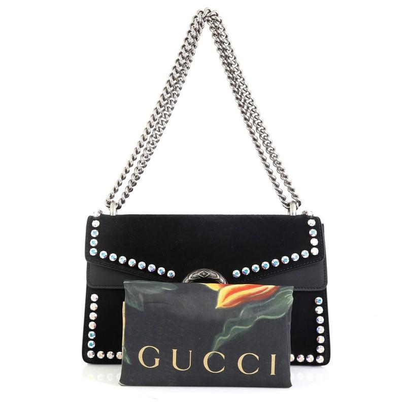 This Gucci Dionysus Bag Crystal Embellished Suede Small, crafted from black suede, features a chain link strap, rhinestone embellishments, textured tiger head spur detail on its flap, and aged silver-tone hardware. Its hidden push-pin closure opens