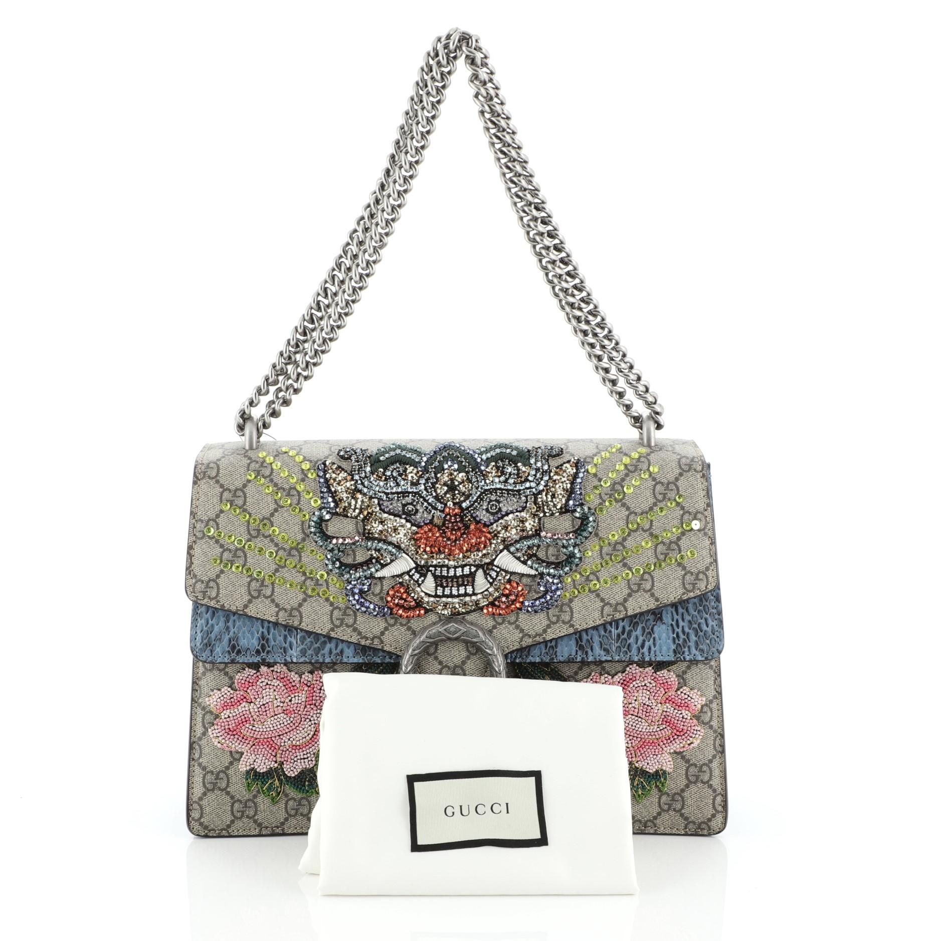 This Gucci Dionysus Bag Embellished GG Coated Canvas with Python Medium, crafted from embelished brown GG coated canvas genuine blue python skin, features chain link strap, textured tiger head spur detail on its flap, embroidery detailing, and aged