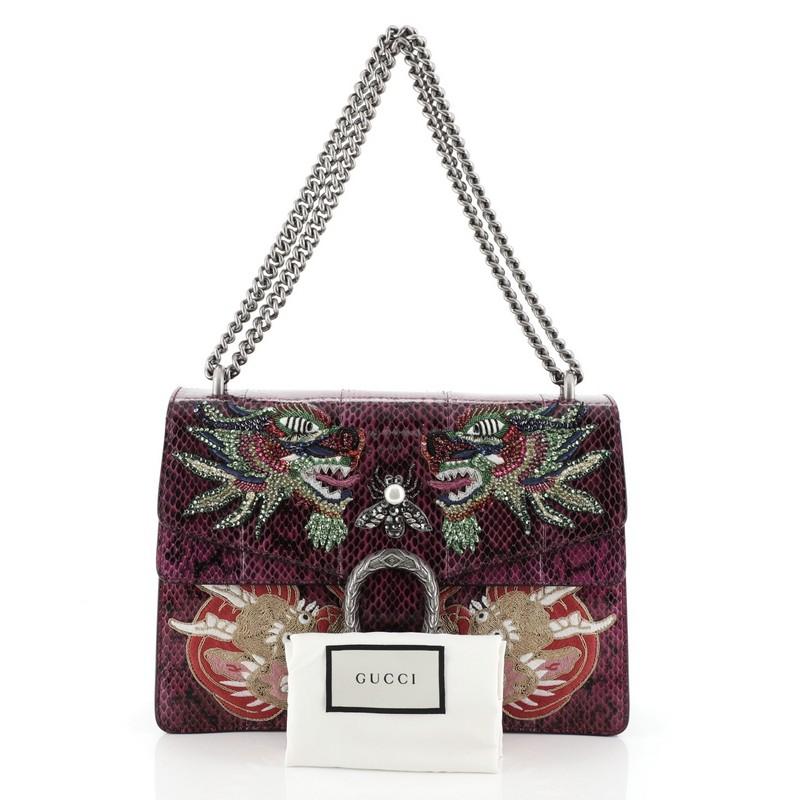 This Gucci Dionysus Bag Embellished Python Medium, crafted from purple genuine python skin with crystal embellishments, features aged silver chain link strap, textured tiger head spur detail on its flap, accordion-like gusseted paneling and aged