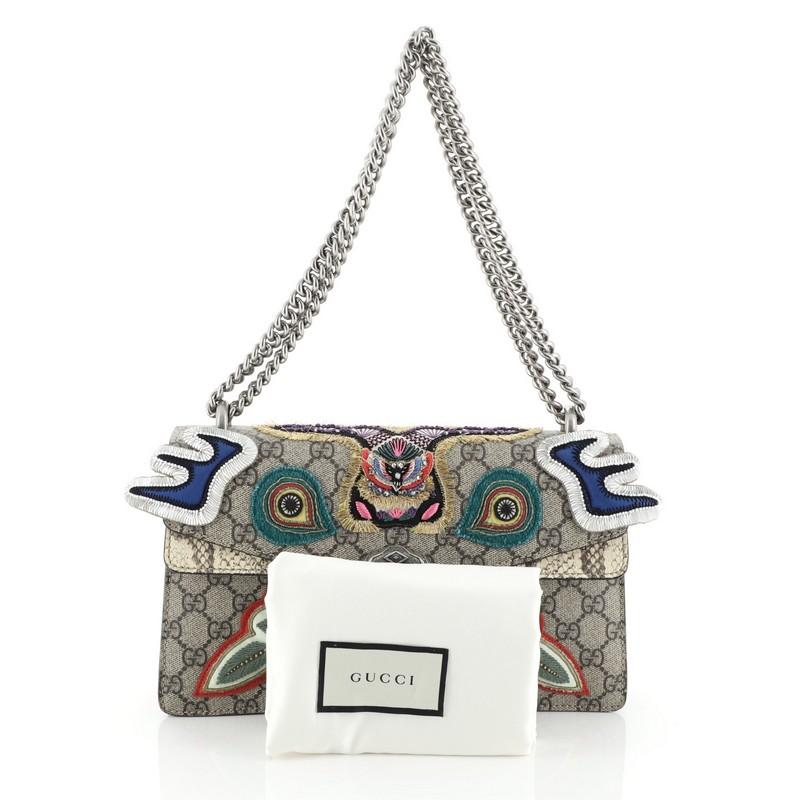 This Gucci Dionysus Bag Embroidered GG Coated Canvas with Python Small, crafted from neutral embroidered GG coated canvas with genuine python, features a chain link strap, multicolored embroidered detailing, and aged silver-tone hardware. Its hidden