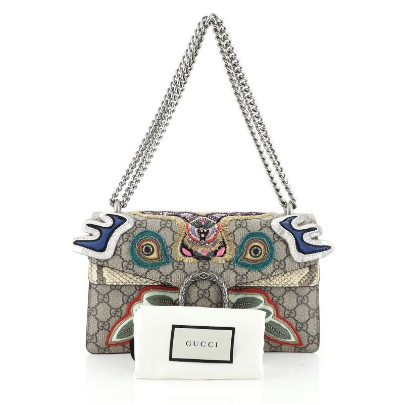 This Gucci Dionysus Bag Embroidered GG Coated Canvas with Python Small, crafted from brown embroidered GG coated canvas with genuine python, features a chain link strap, multicolored embroidered detailing, and aged silver-tone hardware. Its hidden