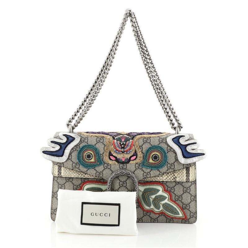 This Gucci Dionysus Bag Embroidered GG Coated Canvas with Python Small, crafted from brown embroidered GG coated canvas with genuine python, features a chain link strap, multicolored embroidered detailing, and aged silver-tone hardware. Its hidden