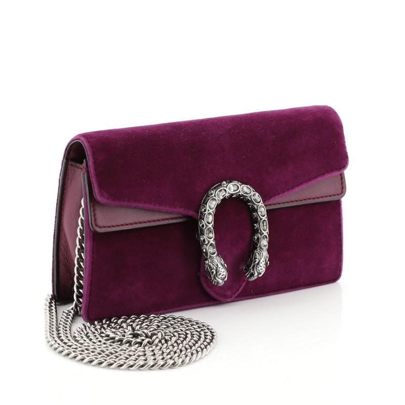 This Gucci Dionysus Bag Velvet Super Mini, crafted from purple velvet, features chain link strap, textured tiger head spur detail on its flap, and silver-tone hardware. Its hidden push-pin closure opens to a neutral microfiber interior. 

Estimated