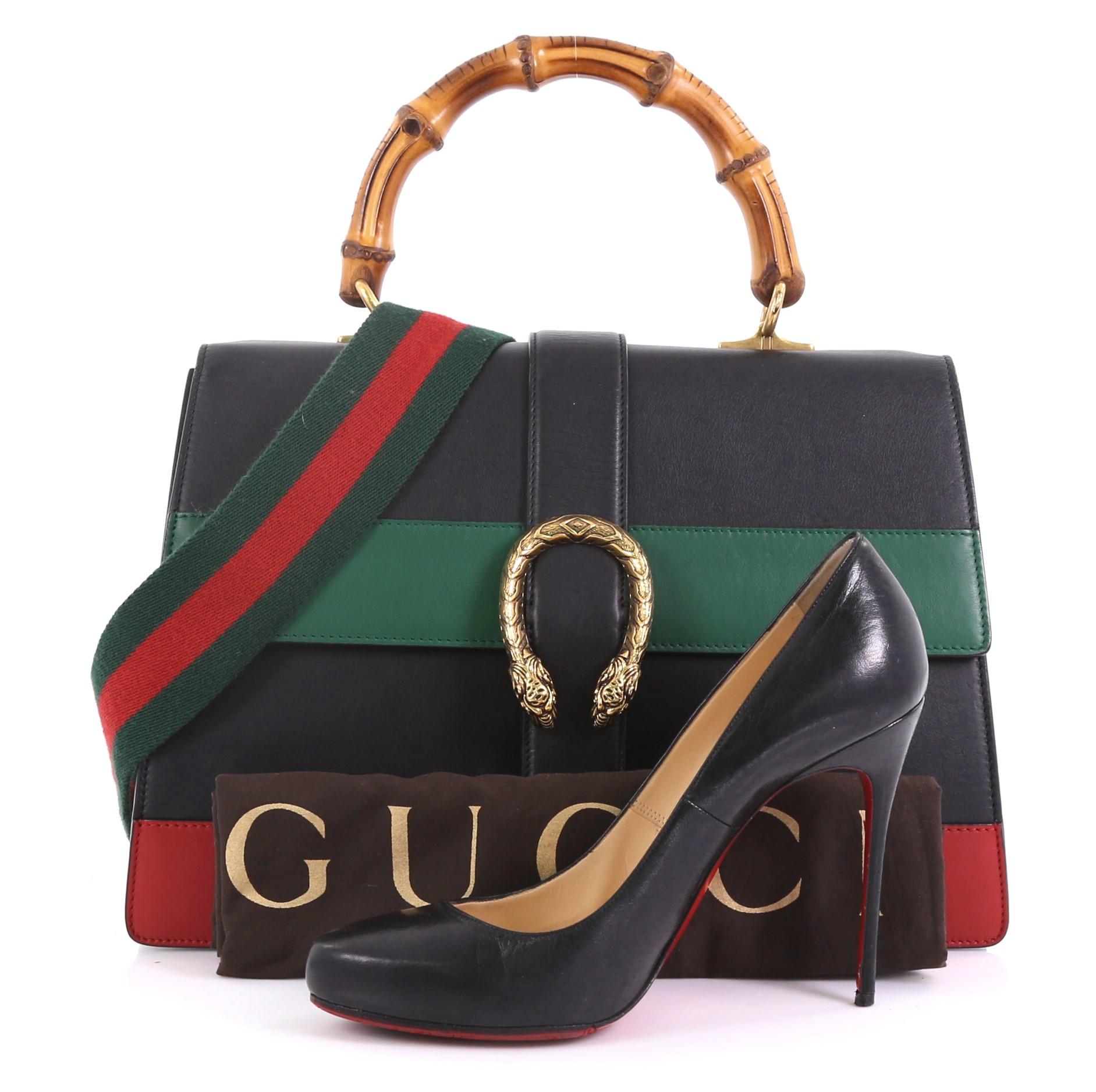 This Gucci Dionysus Bamboo Top Handle Bag Colorblock Leather Large, crafted from black, red and green leather, features a bamboo top handle, textured tiger head spur detail on its flap, and aged gold-tone hardware. Its closure with side release