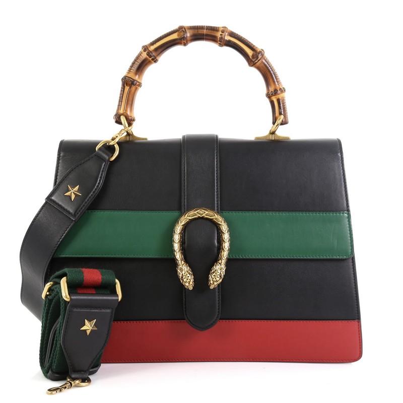 This Gucci Dionysus Bamboo Top Handle Bag Colorblock Leather Large, crafted from black leather, features a bamboo top handle, textured tiger head spur detail on its flap, and aged gold-tone hardware. Its closure with side release opens to a neutral