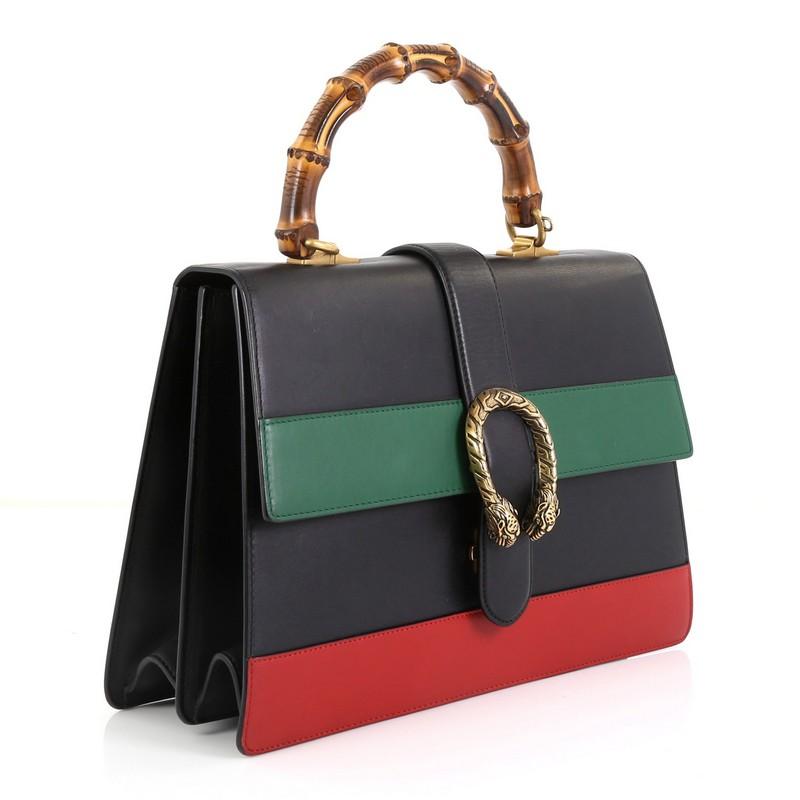 This Gucci Dionysus Bamboo Top Handle Bag Colorblock Leather Large, crafted from black and multicolor leather, features a bamboo top handle, textured tiger head spur detail on its flap, and aged gold-tone hardware. Its closure with side release