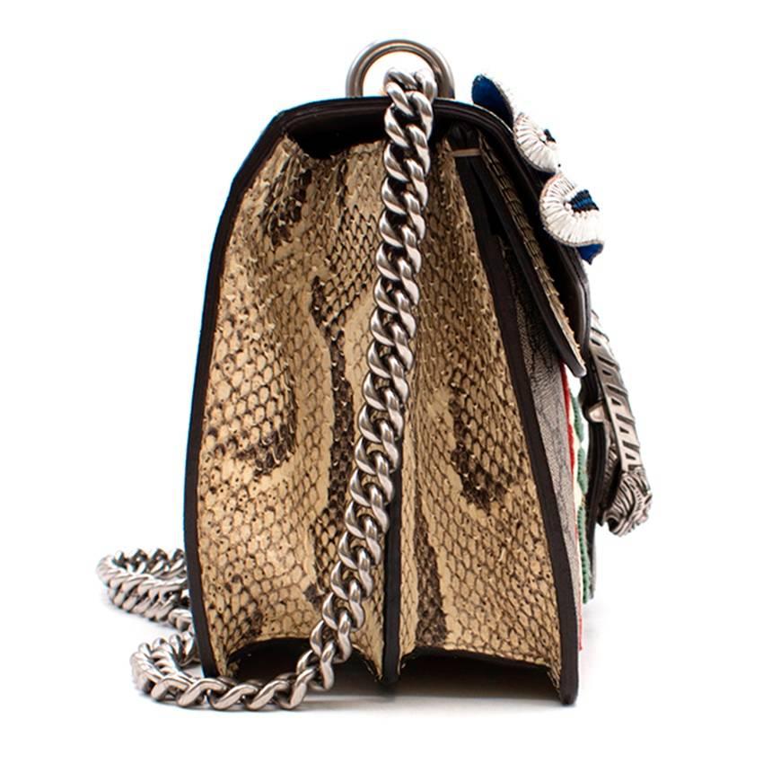 Gucci Dionysus small embroidered shoulder bag

Featuring:
-tiger head pin closure
-a variety of appliquee embroideries that form a face
-hand-embroidered using metallic thread, crystals and pearl beads
-sliding chain strap
-beige/ebony GG Supreme