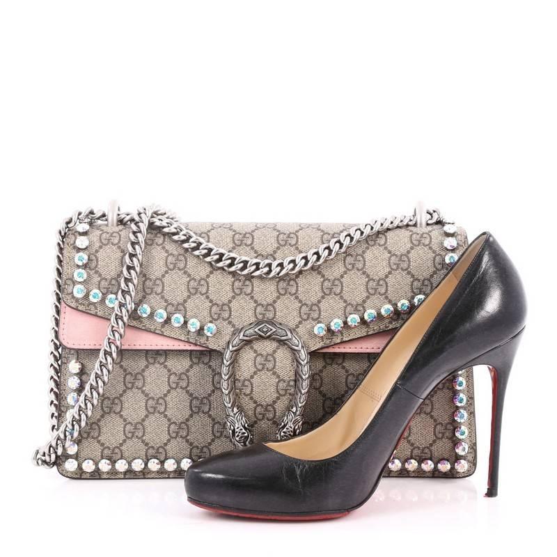 This authentic Gucci Dionysus Handbag Crystal Embellished GG Coated Canvas Small named after the Greek God is a stunning piece. Crafted from light brown GG coated canvas with pink suede trims, this satchel features aged silver chain link strap, faux