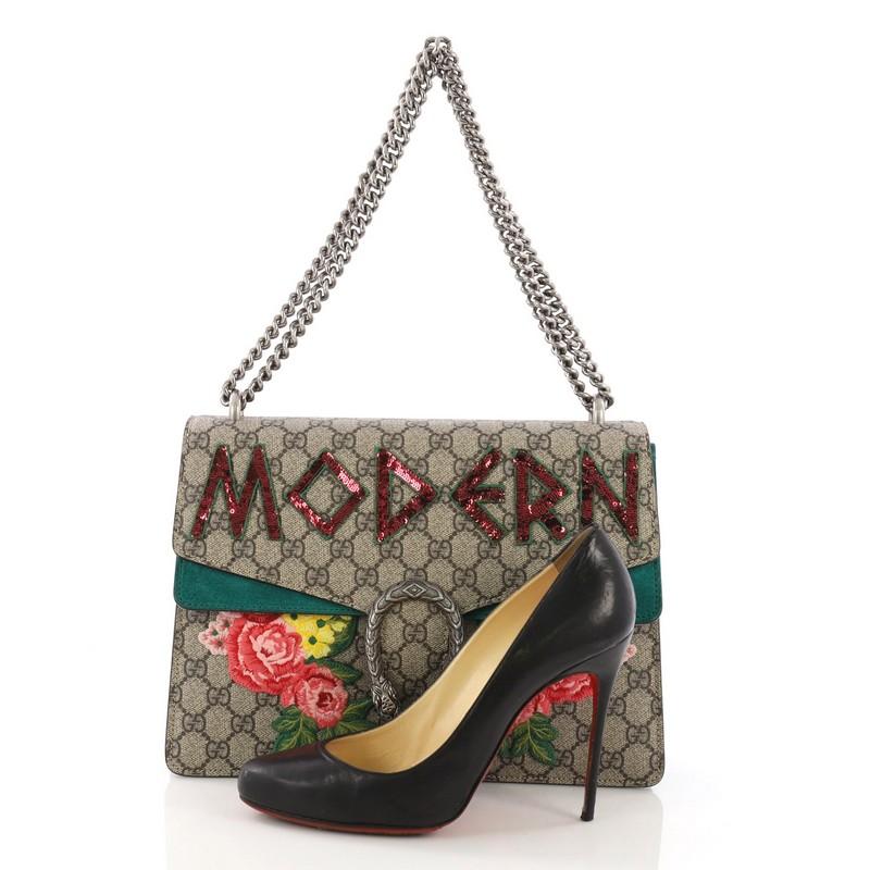This Gucci Dionysus Handbag Embellished GG Coated Canvas Medium, crafted from brown GG coated canvas, features a chain link strap, sequin embellishment, embroidered flower detail, textured tiger head spur detail on its flap, accordion-like gusseted
