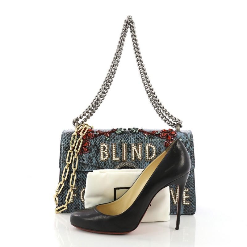 This Gucci Dionysus Handbag Embellished Python Small, crafted from blue embellished genuine python, features an aged silver chain link strap, textured tiger head on its flap, appliqué florals, 'Blind for Love' lettering, accordion-like gusseted side