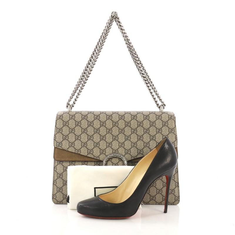 This Gucci Dionysus Handbag GG Coated Canvas Medium, crafted from brown GG coated canvas and suede, features chain link strap, textured tiger head spur detail on its flap, and aged silver-tone hardware. Its hidden push-pin closure opens to a brown