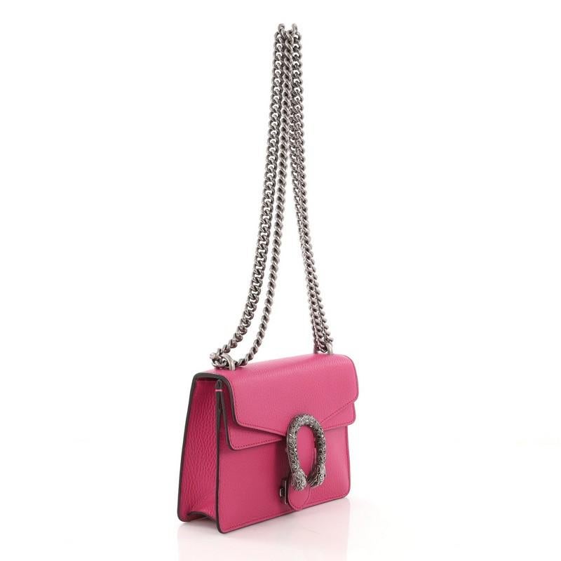 This Gucci Dionysus Handbag Leather Mini, crafted from pink leather, features a chain link strap, textured tiger head spur detail on flap, and aged silver-tone hardware. Its hidden push-pin closure opens to a beige fabric interior. **Note: Shoe