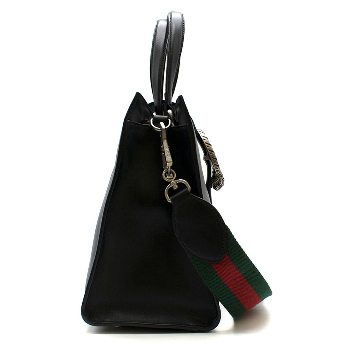 Gucci Dionysus Medium Web-striped leather top-handle bag

- Black, smooth leather 
- Two rolled leather top handles, detachable striped green and red Web canvas shoulder strap 
- Green and red striped leather Web front panel  
- Magnetic-fastening