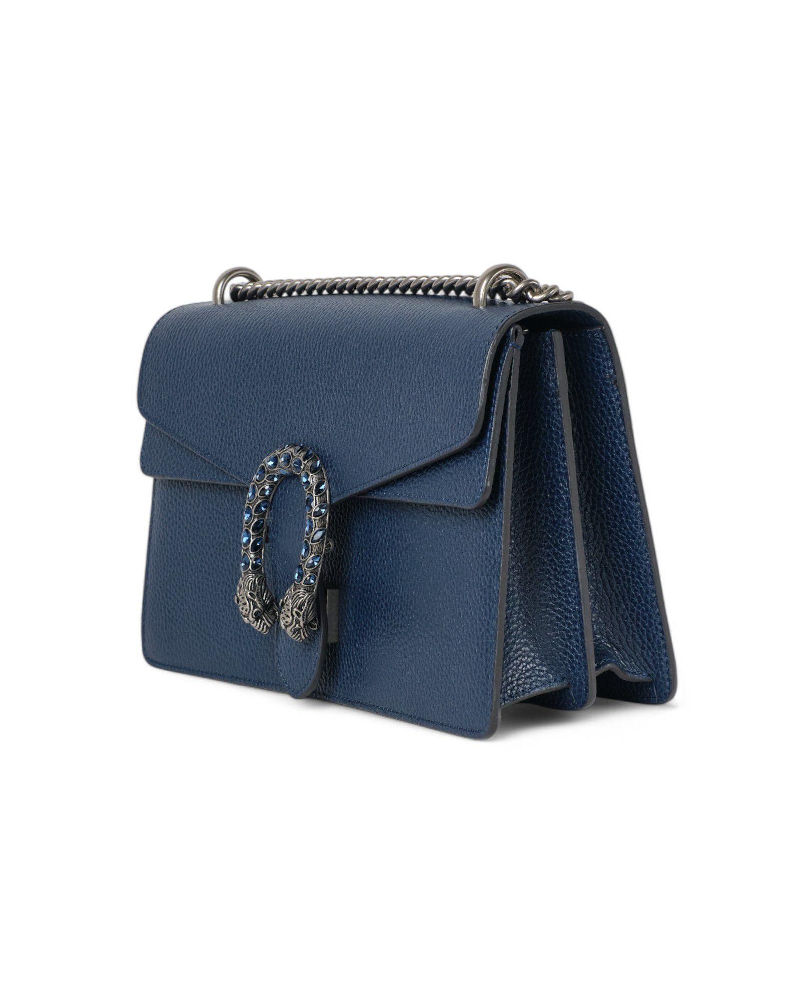 Borsa firmata Gucci, della linea Dionysus nella misura Small, realizzata in pelle martellata nella sofisticata colorazione blu, con dettagli in hardware argento. La chiusura ad incastro con teste di tigre è un distintivo elemento di design che rende