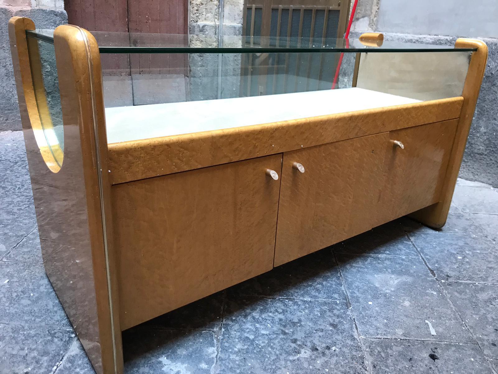 Italian, circa 1980, store fixture in excellent condition. It has a large drawer at the back which slide to enable access to the display. On the front it has three panels. Excellent example of solid craftsmanship and elegant proportions.
