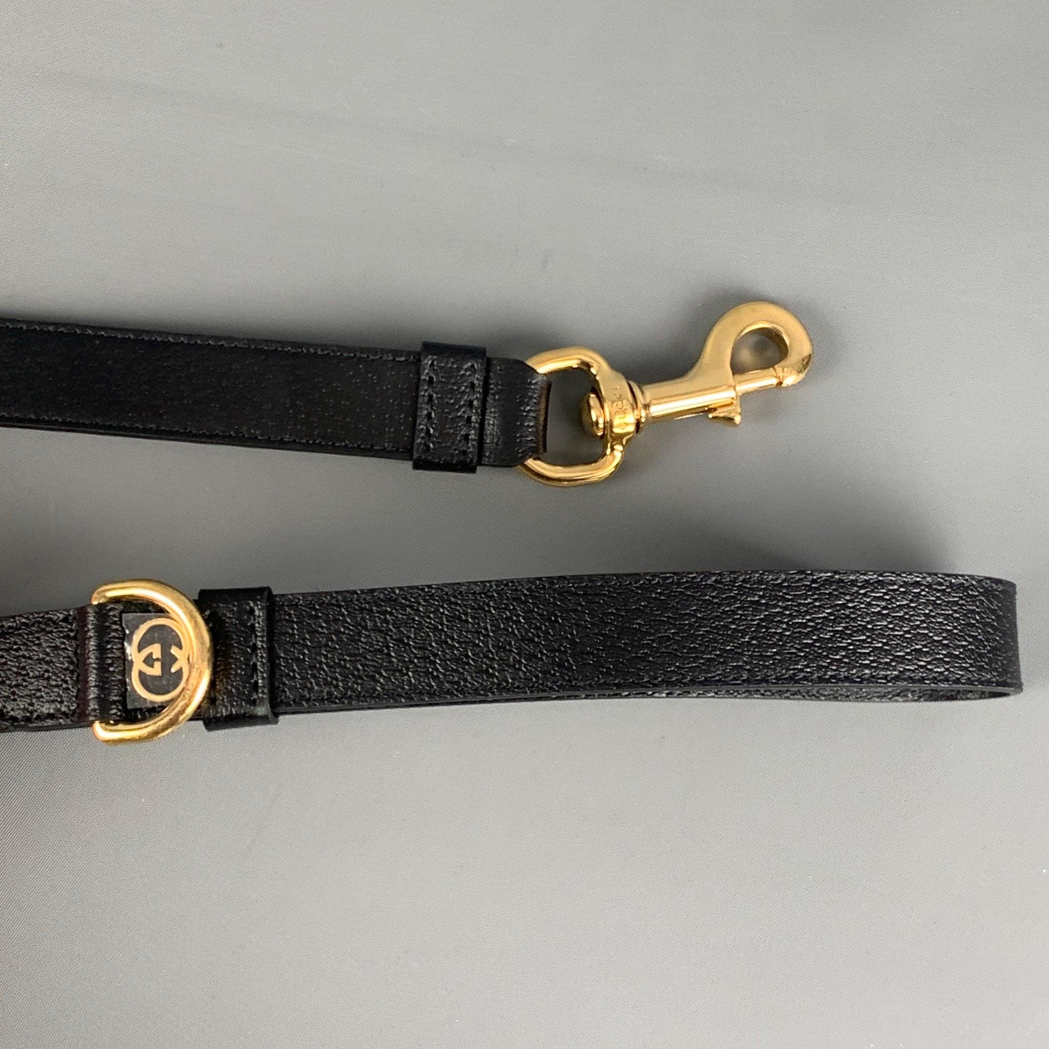 GUCCI dog leash in black embossed leather featuring a gold tone hardware, interlocking G detail, and clasp closure. Made in Italy. Comes with dust bag.Excellent Pre-Owned Condition.  

Marked:   695257 2ZROG U 525040 

Measurements: 
   39.4 inches 