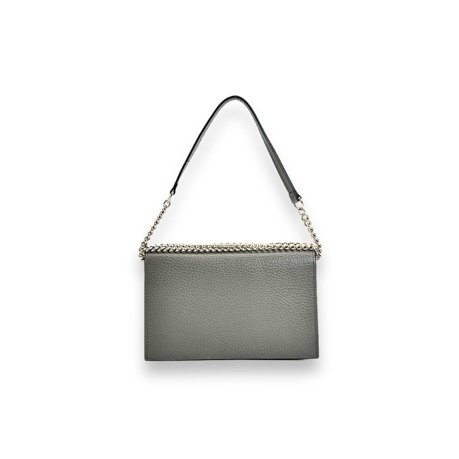Indulge in luxury with the Gucci Dollar Calfskin Interlocking G Wallet on Chain. Crafted with high-quality grey calfskin leather and featuring a snap closure at the front, this wallet exudes sophistication. With ample space for cards and a zip